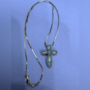 14k gold necklace with a 10k diamond cross including baguettes.